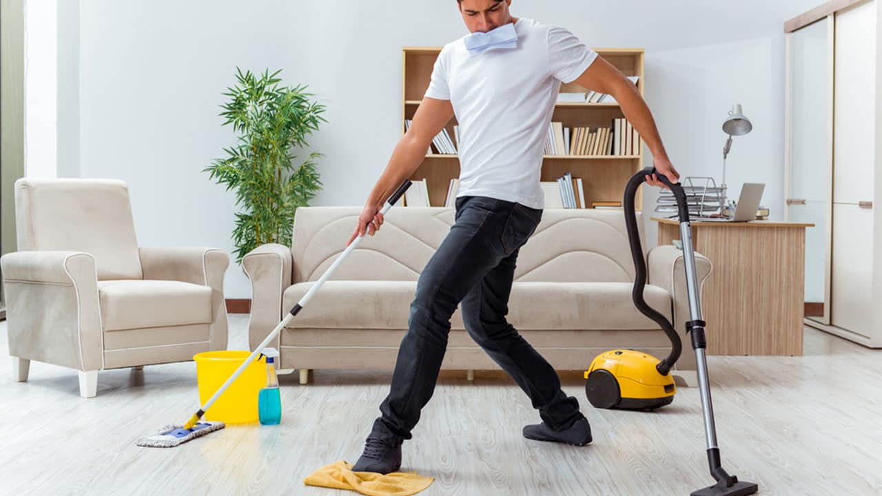 Man doing five cleaning chores at a time.
