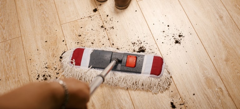 Mopping dirt off of a laminate floor.